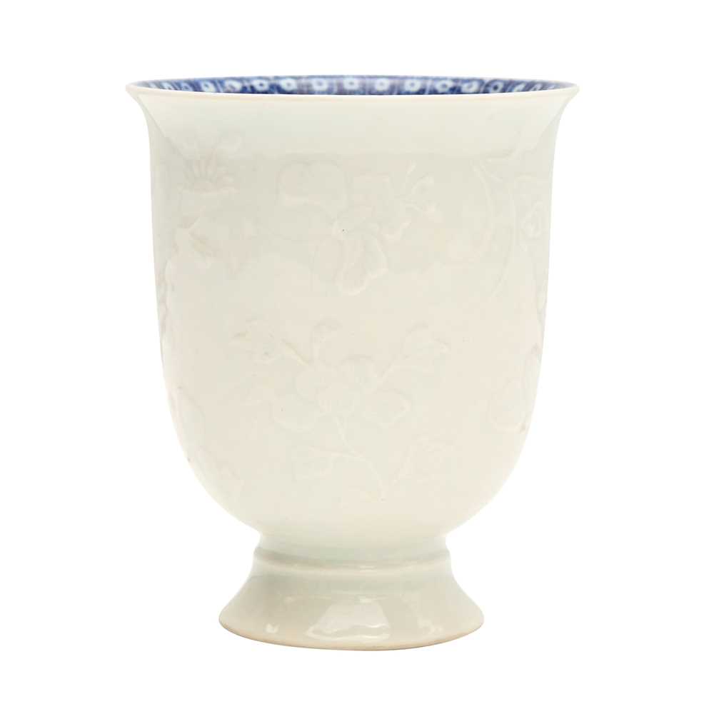 Lot 4 - A Chinese blanc-de-chine relief-decorated cup, Qing dynasty, Kangxi period