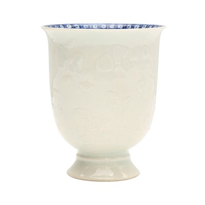 Lot 4 - A Chinese blanc-de-chine relief-decorated cup, Qing dynasty, Kangxi period