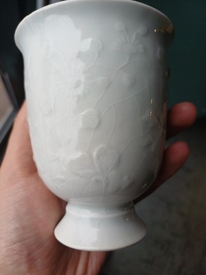 Lot 4 - A Chinese blanc-de-chine relief-decorated cup, Qing dynasty, Kangxi period