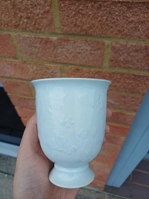Lot 4 - A Chinese blanc-de-chine relief-decorated cup, Qing dynasty, Kangxi period
