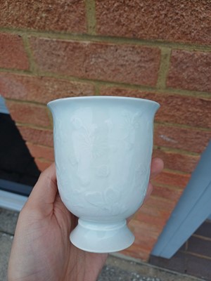 Lot 4 - A Chinese blanc-de-chine relief-decorated cup, Qing dynasty, Kangxi period