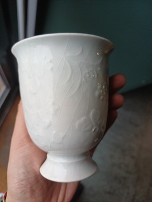 Lot 4 - A Chinese blanc-de-chine relief-decorated cup, Qing dynasty, Kangxi period