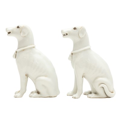 Lot 281 - A pair of Chinese white-glazed figures of dogs, 19th/20th century