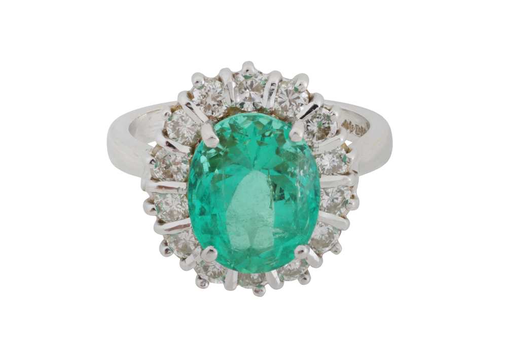 Lot 108 - An emerald and diamond halo ring, circa 1997