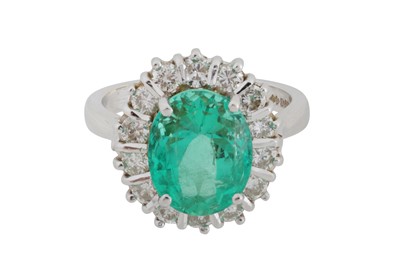 Lot 108 - An emerald and diamond halo ring, circa 1997