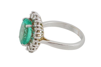 Lot 108 - An emerald and diamond halo ring, circa 1997