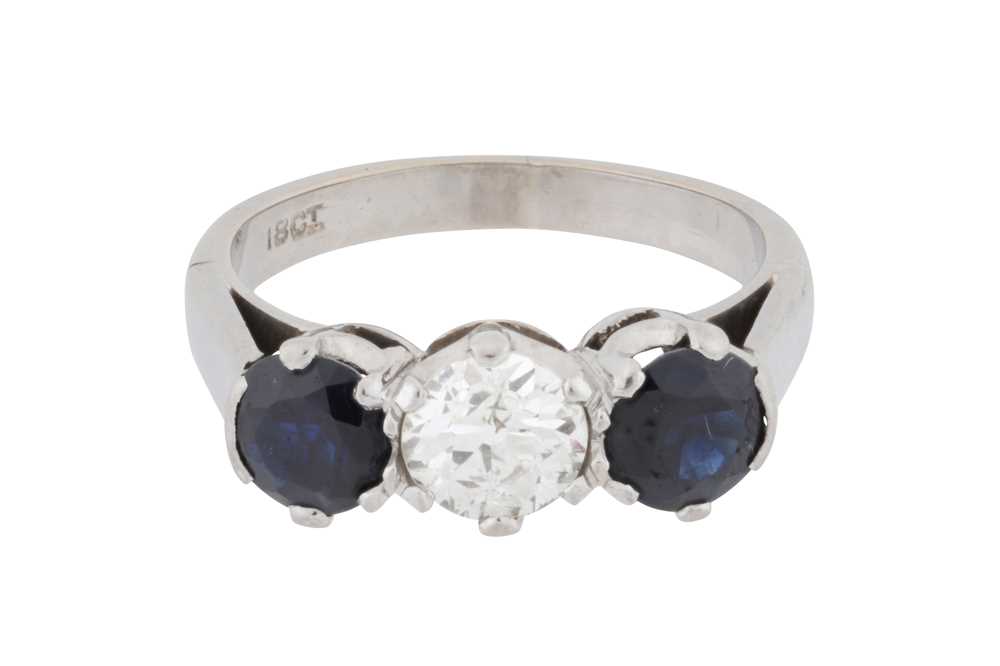 Lot 75 - A diamond and sapphire three-stone ring