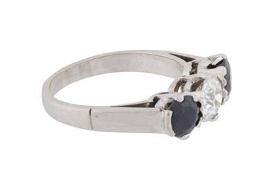 Lot 75 - A diamond and sapphire three-stone ring