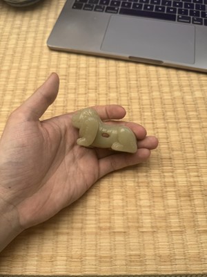 Lot 85 - A Chinese celadon jade carving of a lion, Qing Dynasty, 18th/19th century