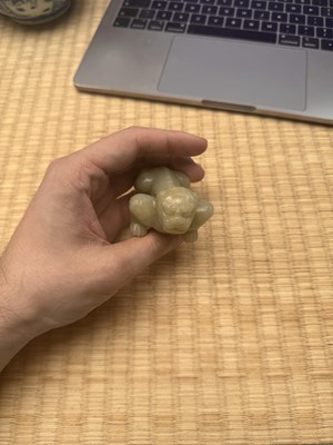 Lot 85 - A Chinese celadon jade carving of a lion, Qing Dynasty, 18th/19th century