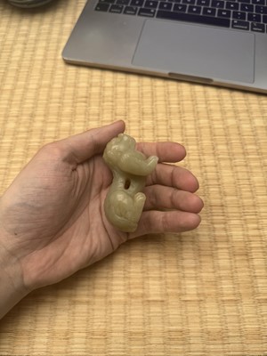 Lot 85 - A Chinese celadon jade carving of a lion, Qing Dynasty, 18th/19th century