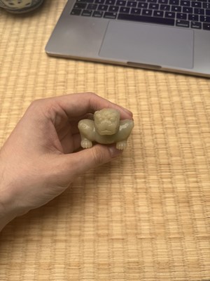 Lot 85 - A Chinese celadon jade carving of a lion, Qing Dynasty, 18th/19th century