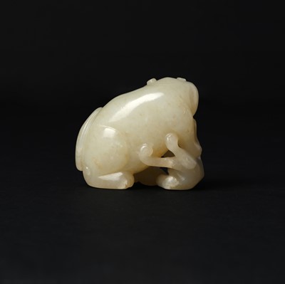 Lot 94 - A Chinese celadon and russet jade 'cats' carving, Qing dynasty, 19th century