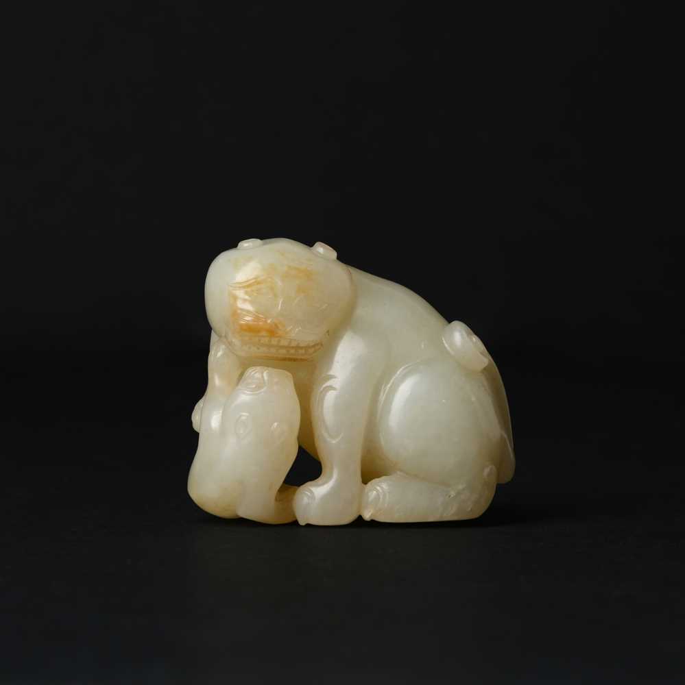 Lot 94 - A Chinese celadon and russet jade 'cats' carving, Qing dynasty, 19th century