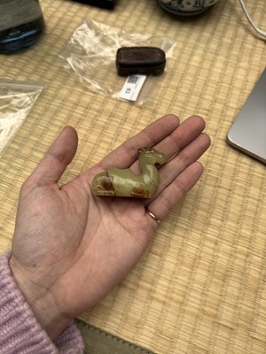 Lot 83 - A Chinese yellow jade carving of a camel, Qing dynasty
