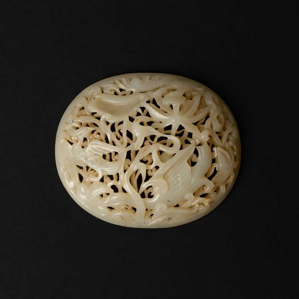 Lot 82 - A Chinese Yuan-style celadon jade reticulated cover, late Ming / early Qing dynasty
