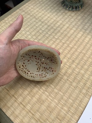 Lot 82 - A Chinese Yuan-style celadon jade reticulated cover, late Ming / early Qing dynasty