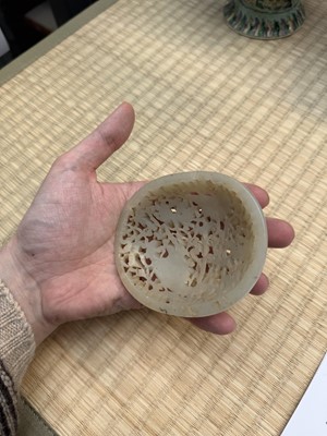 Lot 82 - A Chinese Yuan-style celadon jade reticulated cover, late Ming / early Qing dynasty