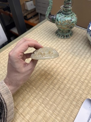 Lot 82 - A Chinese Yuan-style celadon jade reticulated cover, late Ming / early Qing dynasty