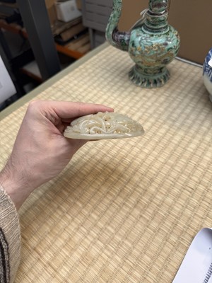 Lot 82 - A Chinese Yuan-style celadon jade reticulated cover, late Ming / early Qing dynasty