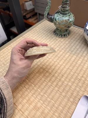 Lot 82 - A Chinese Yuan-style celadon jade reticulated cover, late Ming / early Qing dynasty