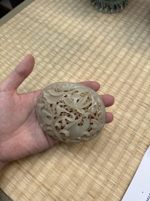 Lot 82 - A Chinese Yuan-style celadon jade reticulated cover, late Ming / early Qing dynasty