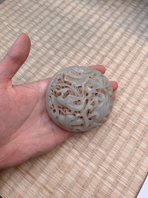 Lot 82 - A Chinese Yuan-style celadon jade reticulated cover, late Ming / early Qing dynasty