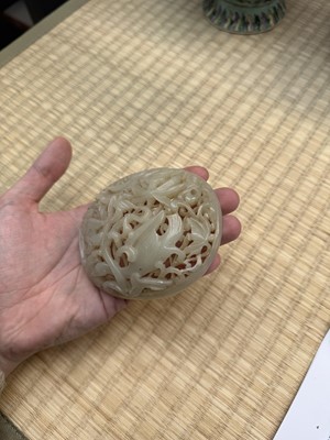 Lot 82 - A Chinese Yuan-style celadon jade reticulated cover, late Ming / early Qing dynasty