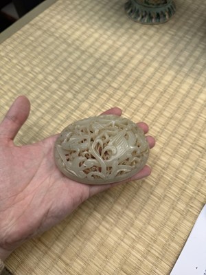 Lot 82 - A Chinese Yuan-style celadon jade reticulated cover, late Ming / early Qing dynasty