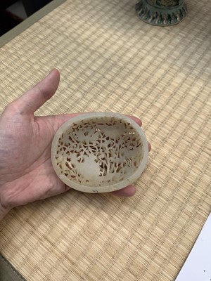 Lot 82 - A Chinese Yuan-style celadon jade reticulated cover, late Ming / early Qing dynasty