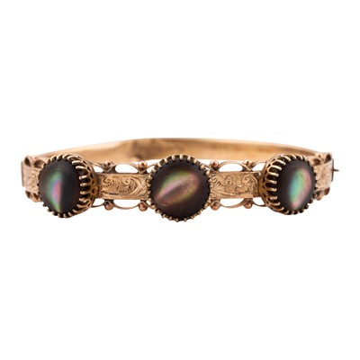 Lot 130 - A black mother of pearl bangle
