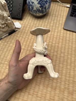 Lot 32 - A Chinese Dehua 'dragon' tripod candlestick, Qing dynasty, Kangxi period