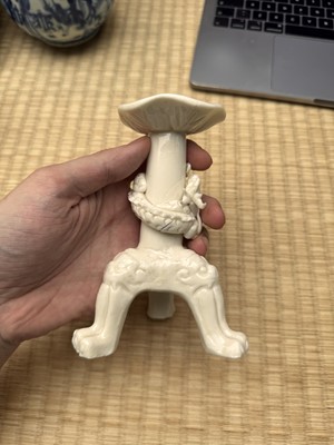 Lot 32 - A Chinese Dehua 'dragon' tripod candlestick, Qing dynasty, Kangxi period