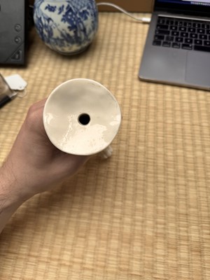 Lot 32 - A Chinese Dehua 'dragon' tripod candlestick, Qing dynasty, Kangxi period