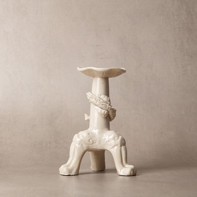 Lot 32 - A Chinese Dehua 'dragon' tripod candlestick, Qing dynasty, Kangxi period