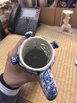 Lot 18 - A rare Chinese export blue and white 'puzzle' jug, Qing dynasty, Kangxi period