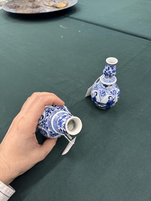 Lot 17 - A pair of small Chinese blue and white vases, Qing dynasty, Kangxi period
