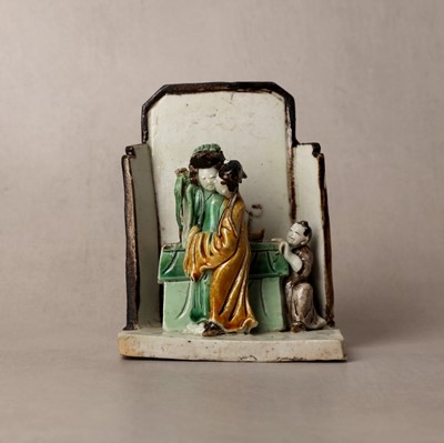 Lot 25 - A Chinese sancai-glazed biscuit 'love scene' brush holder, Qing dynasty, Kangxi period, circa 1690
