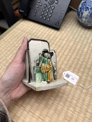 Lot 25 - A Chinese sancai-glazed biscuit 'love scene' brush holder, Qing dynasty, Kangxi period, circa 1690