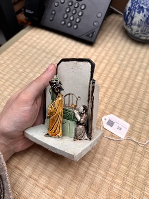 Lot 25 - A Chinese sancai-glazed biscuit 'love scene' brush holder, Qing dynasty, Kangxi period, circa 1690