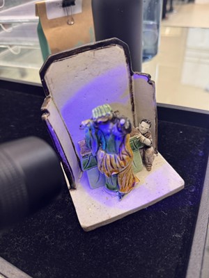 Lot 25 - A Chinese sancai-glazed biscuit 'love scene' brush holder, Qing dynasty, Kangxi period, circa 1690