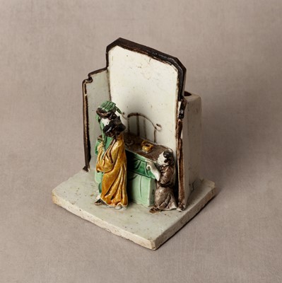 Lot 25 - A Chinese sancai-glazed biscuit 'love scene' brush holder, Qing dynasty, Kangxi period, circa 1690