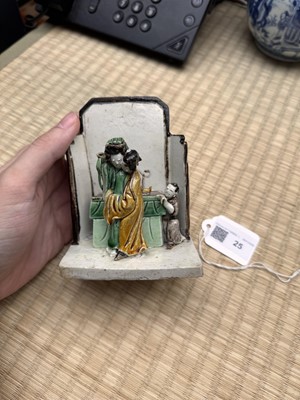 Lot 25 - A Chinese sancai-glazed biscuit 'love scene' brush holder, Qing dynasty, Kangxi period, circa 1690