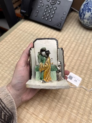 Lot 25 - A Chinese sancai-glazed biscuit 'love scene' brush holder, Qing dynasty, Kangxi period, circa 1690