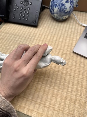 Lot 37 - A Chinese blanc-de-chine 'piggyback' figure group, Qing dynasty, Qianlong period, circa 1760