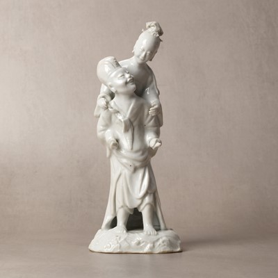 Lot 37 - A Chinese blanc-de-chine 'piggyback' figure group, Qing dynasty, Qianlong period, circa 1760