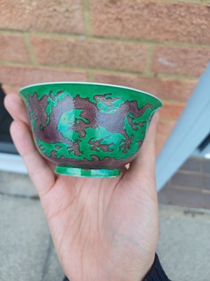 Lot 22 - ♦ A rare Chinese Imperial aubergine-enamelled 'dragon' bowl, Qing dynasty, Kangxi mark and period