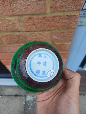 Lot 22 - ♦ A rare Chinese Imperial aubergine-enamelled 'dragon' bowl, Qing dynasty, Kangxi mark and period