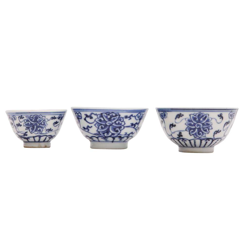 Lot 443 - Three Chinese blue and white 'lotus' cups, Qing dynasty, 18th/19th century