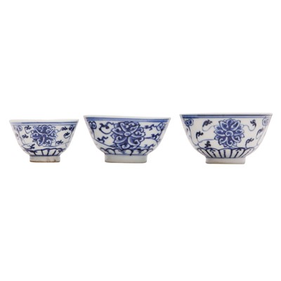 Lot 443 - Three Chinese blue and white 'lotus' cups, Qing dynasty, 18th/19th century